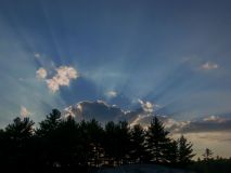 36The sun defies its demise, shooting rays into the sky's blue breadth